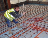 Using a laser-level prior to screeding on underfloor heating